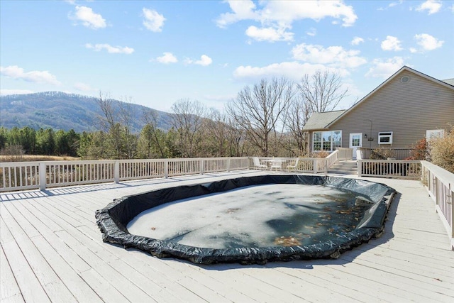 view of pool featuring a deck with mountain view