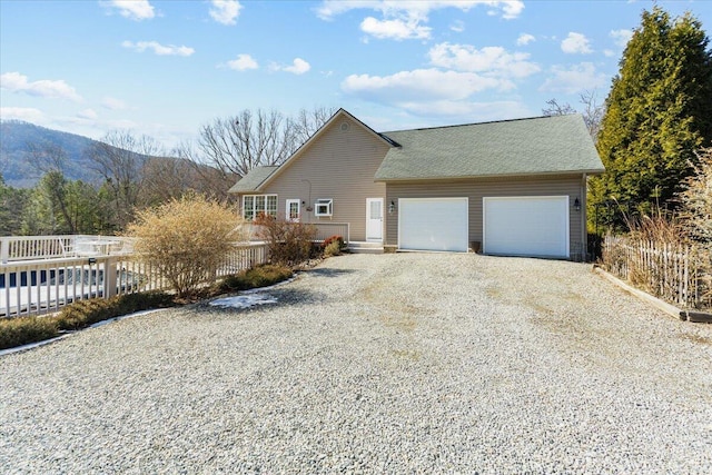 view of front facade featuring a mountain view and a garage