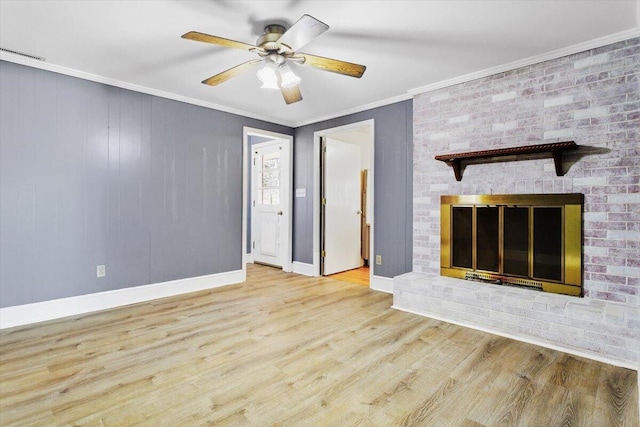 unfurnished living room with crown molding, a fireplace, light hardwood / wood-style floors, and ceiling fan