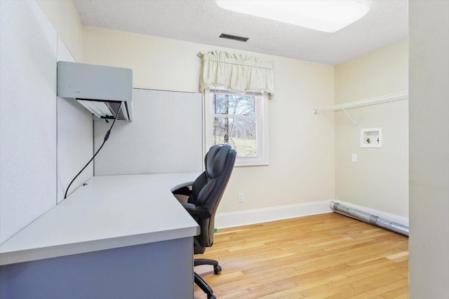 office featuring hardwood / wood-style floors and a textured ceiling