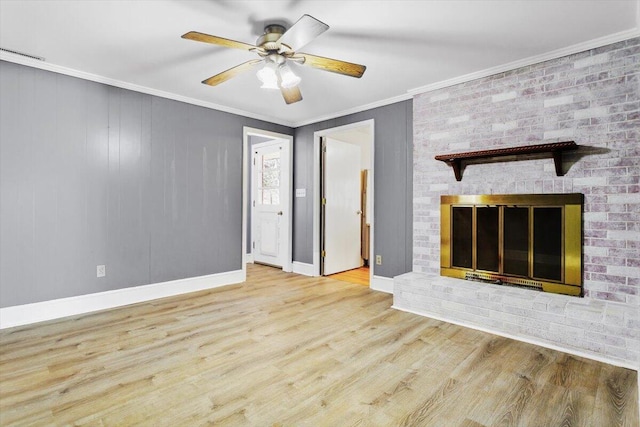 unfurnished living room featuring a fireplace, wood finished floors, a ceiling fan, baseboards, and ornamental molding