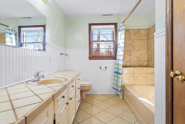 full bathroom with vanity, shower / tub combo, tile patterned floors, and toilet