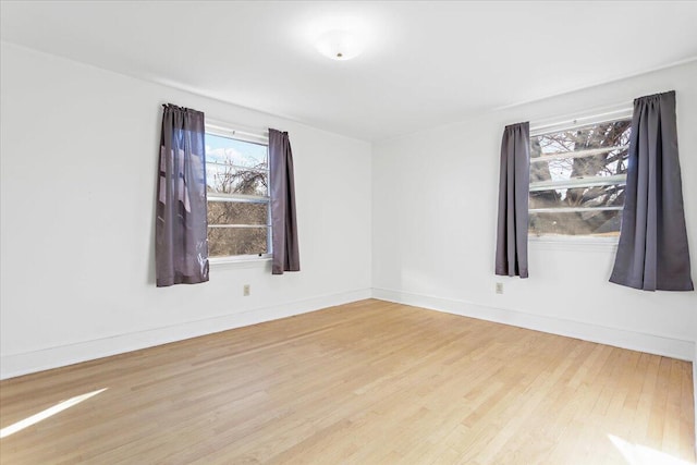 unfurnished room featuring hardwood / wood-style flooring