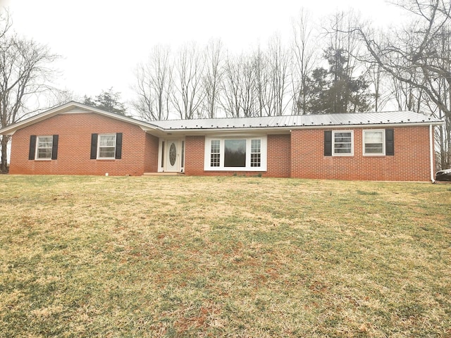 ranch-style home with a front lawn, metal roof, and brick siding