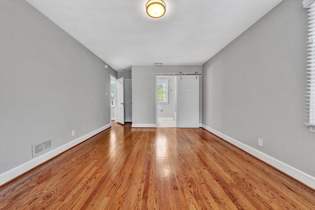 interior space featuring light hardwood / wood-style flooring and a barn door