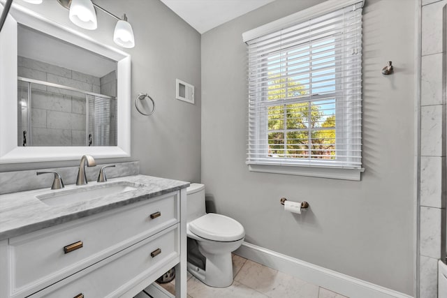 bathroom with an enclosed shower, vanity, and toilet