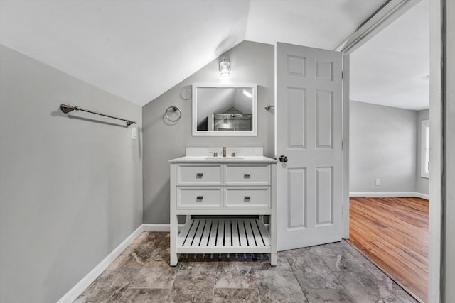 bathroom with vaulted ceiling and vanity