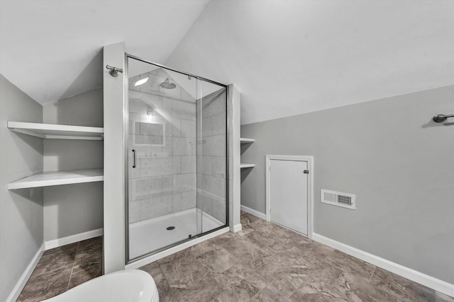 bathroom with an enclosed shower, vaulted ceiling, and toilet