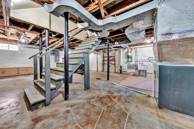 basement featuring electric panel and sink