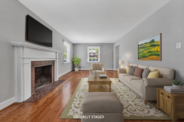 living room featuring a fireplace and light wood-type flooring