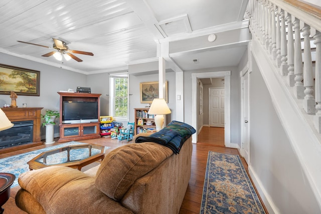 living room featuring ceiling fan, wood-type flooring, and ornamental molding