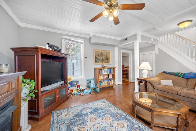 living room with ceiling fan, hardwood / wood-style floors, and ornamental molding