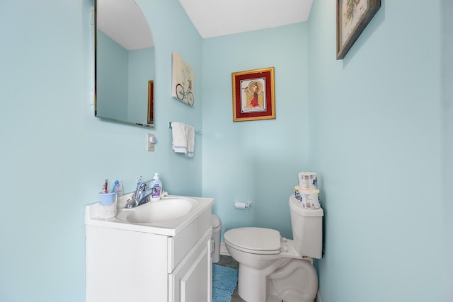 bathroom featuring toilet and vanity