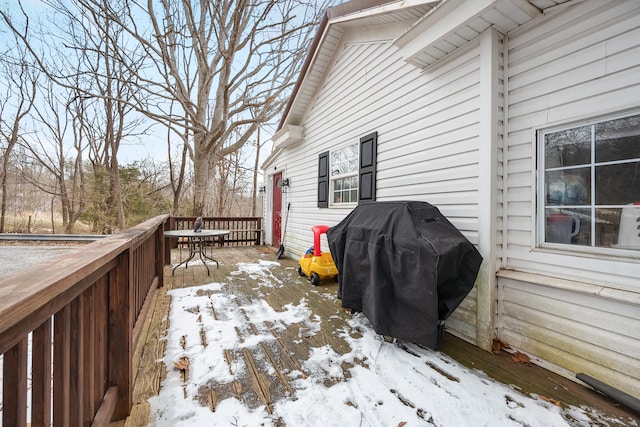 snow covered deck featuring area for grilling