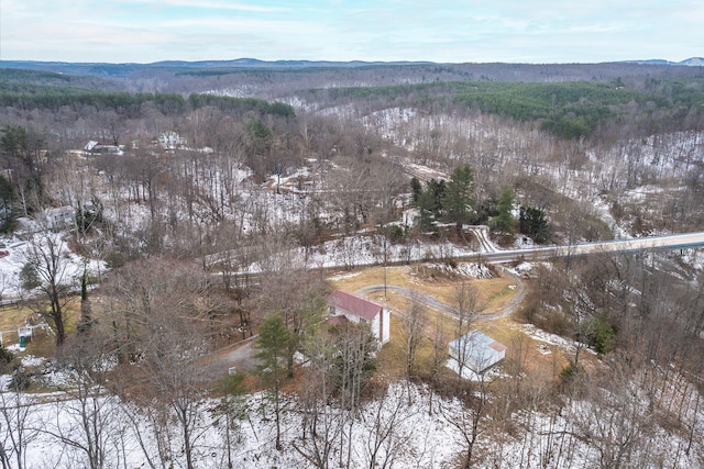 snowy aerial view with a mountain view