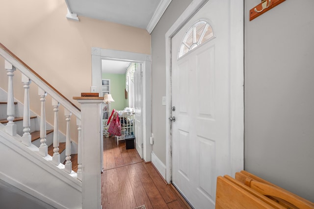 foyer entrance featuring crown molding and hardwood / wood-style floors