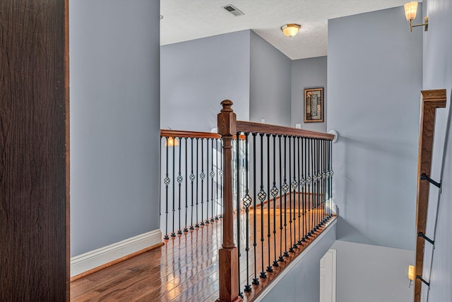 stairway with hardwood / wood-style flooring