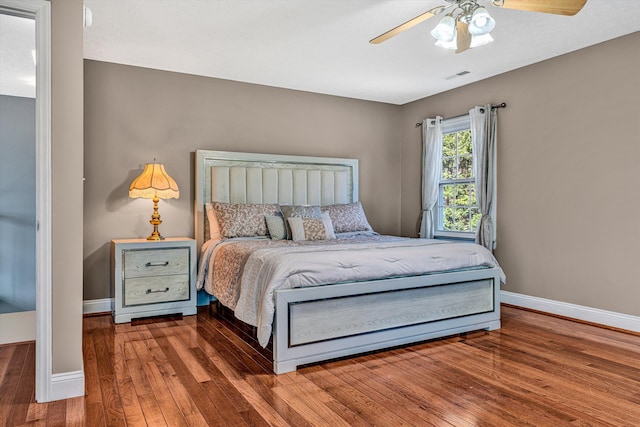 bedroom featuring ceiling fan and dark hardwood / wood-style floors