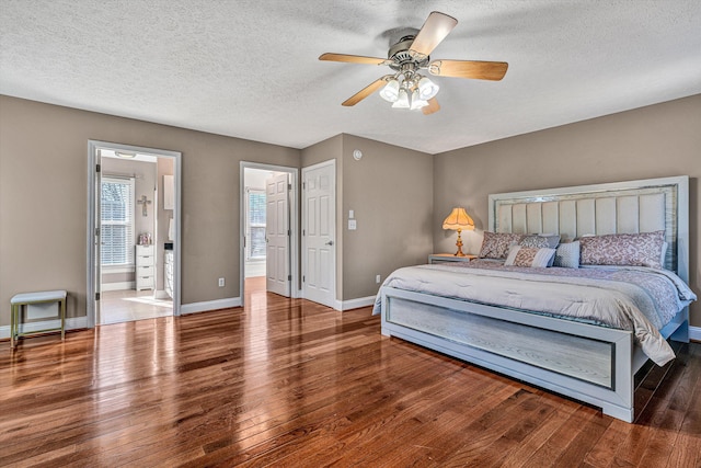 bedroom with ceiling fan, wood-type flooring, a textured ceiling, and ensuite bath