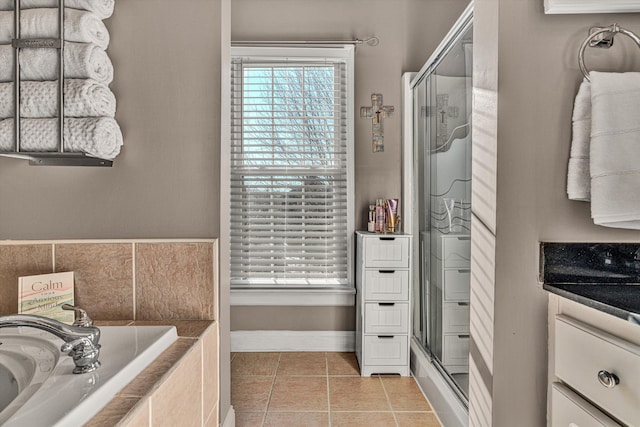 bathroom with a wealth of natural light, vanity, separate shower and tub, and tile patterned flooring