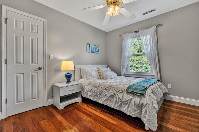 bedroom with dark wood-type flooring and ceiling fan