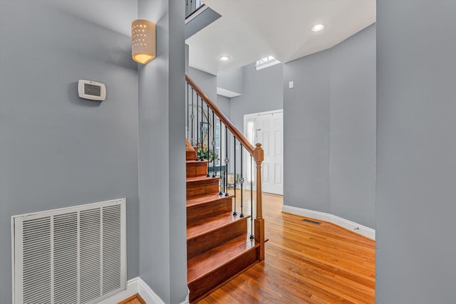 staircase with hardwood / wood-style floors