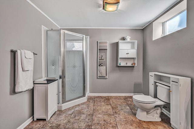 bathroom with toilet, a shower with shower door, and ornamental molding