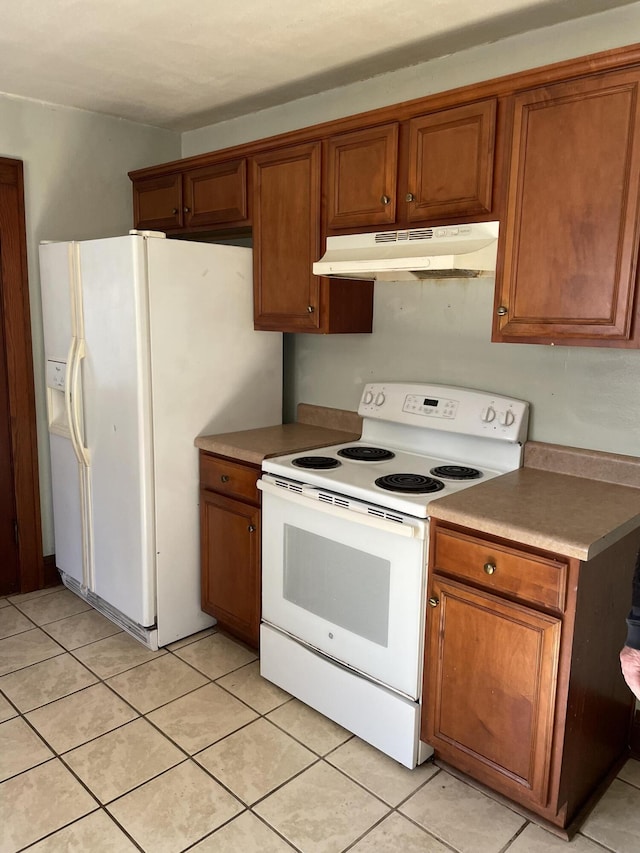 kitchen with white appliances and light tile patterned floors