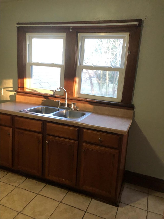 kitchen with sink and light tile patterned floors