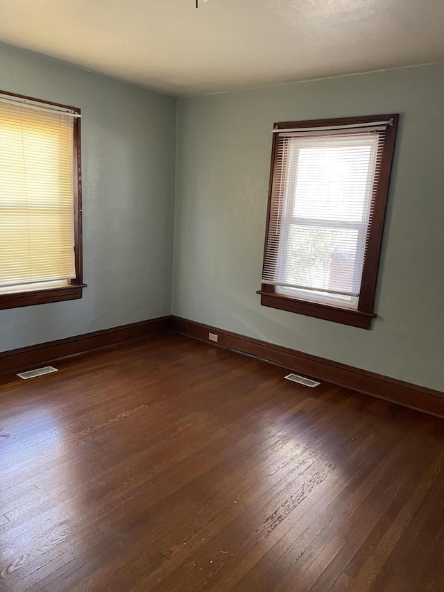 spare room with dark wood-type flooring