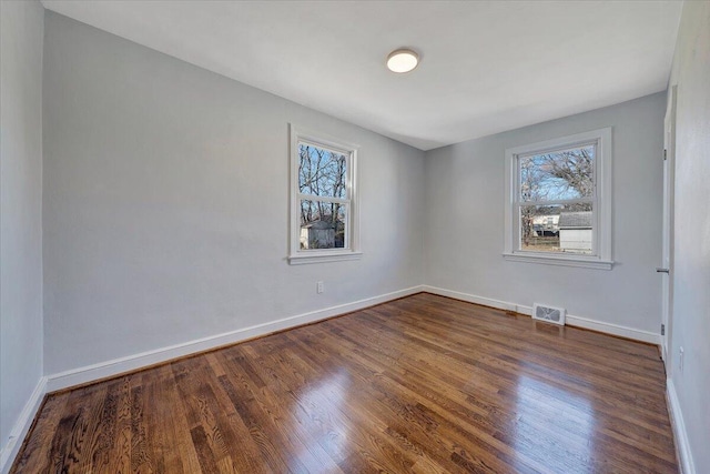 spare room with dark hardwood / wood-style flooring