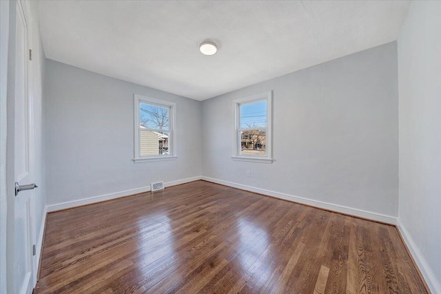 empty room with dark wood-type flooring