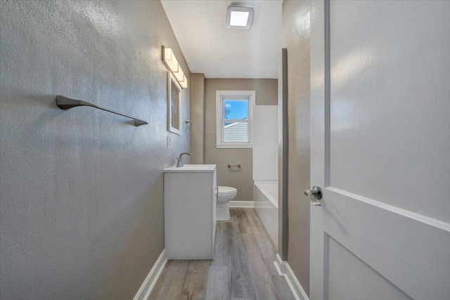 full bathroom featuring toilet, vanity, bathing tub / shower combination, and hardwood / wood-style floors