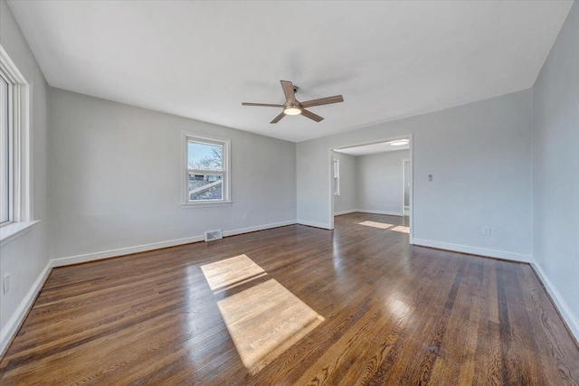 spare room with ceiling fan and dark hardwood / wood-style floors