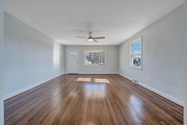 unfurnished room with ceiling fan and dark hardwood / wood-style floors