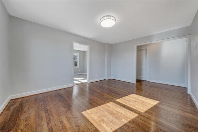 spare room with dark wood-type flooring