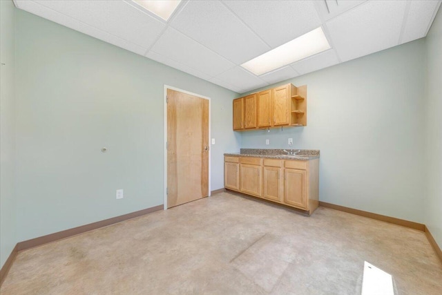 kitchen with a drop ceiling and sink