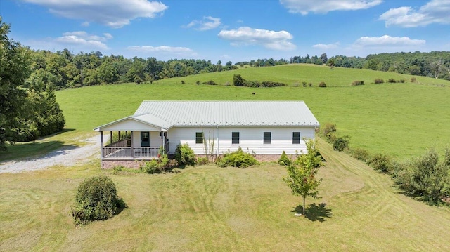 exterior space with a yard, a rural view, and a porch