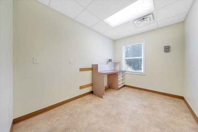 carpeted office featuring a paneled ceiling