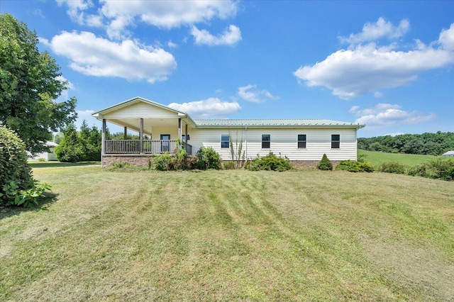 rear view of property with a yard and a porch