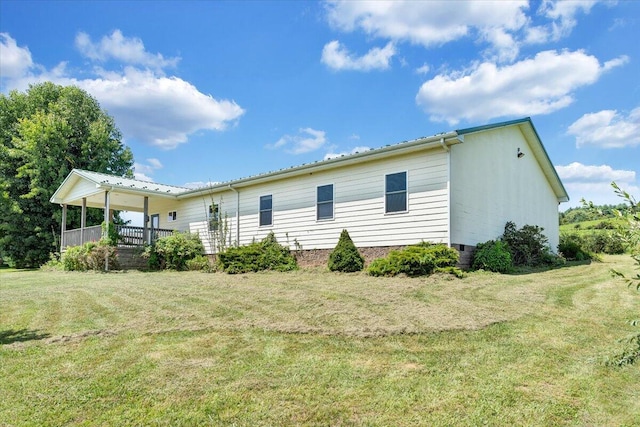 rear view of property with a yard