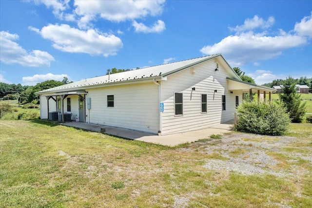 back of house featuring a patio area, cooling unit, and a yard