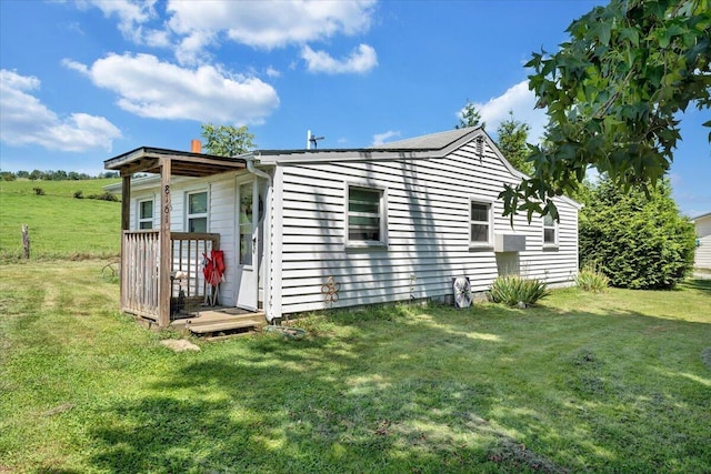 rear view of house featuring a lawn