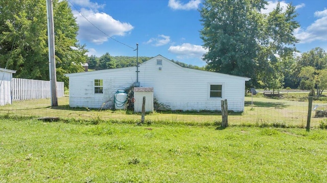 view of side of home featuring a lawn