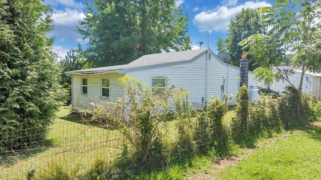 view of side of home with a lawn