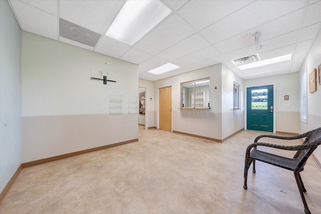 interior space with a paneled ceiling