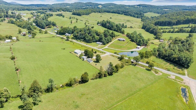 birds eye view of property with a water view and a rural view