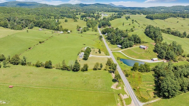 aerial view featuring a water and mountain view and a rural view