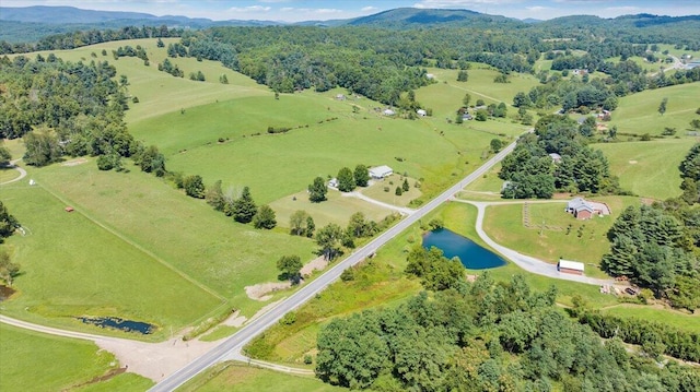 drone / aerial view featuring a water and mountain view and a rural view