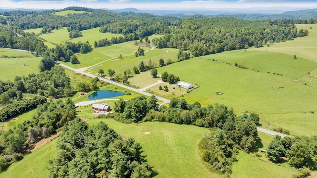 drone / aerial view with a water and mountain view and a rural view